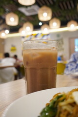 Refreshing iced chocolate drink in a clear glass at a restaurant