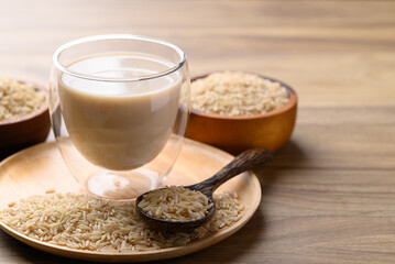 Organic rice milk in cup glass on wooden background, Alternative milk made from plant