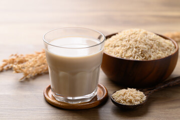 Organic rice milk in cup glass on wooden background, Alternative milk made from plant