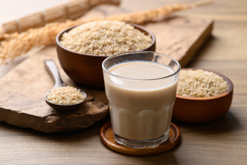 Organic rice milk in cup glass on wooden background, Alternative milk made from plant