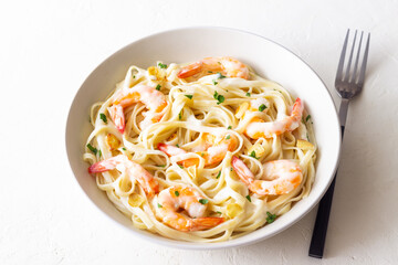 Linguine pasta in creamy garlic sauce with shrimps. Italian food.
