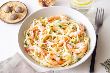 Linguine pasta in creamy garlic sauce with shrimps. Italian food.