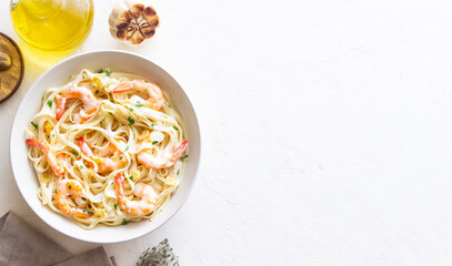 Linguine pasta in creamy garlic sauce with shrimps. Italian food.