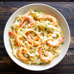 Linguine pasta in creamy garlic sauce with shrimps. Italian food.
