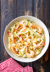 Linguine pasta in creamy garlic sauce with shrimps. Italian food.