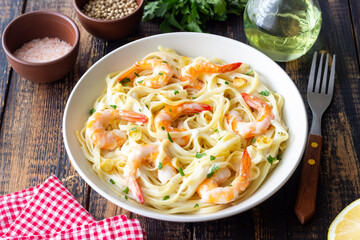Linguine pasta in creamy garlic sauce with shrimps. Italian food.