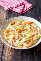 Linguine pasta in creamy garlic sauce with shrimps. Italian food.