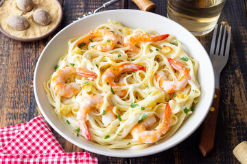 Linguine pasta in creamy garlic sauce with shrimps. Italian food.
