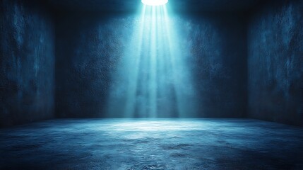 A stark image, showing an empty room with concrete walls illuminated by a single ray of light from above. Useful for illustrating themes of isolation.

