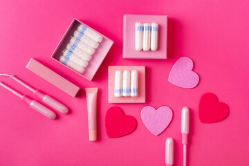Many menstrual hygiene tampons from above on pink background in beautiful composition. Soft cotton absorbent menstrual tampons for women during menstruation. Feminine hygiene. 