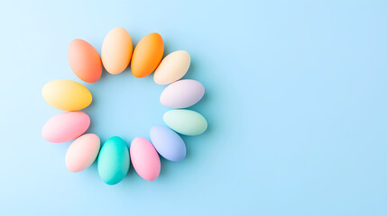 Bright pastel Easter eggs arranged in a circular pattern on a soft blue background. Ideal for greeting cards, festive invitations, or seasonal digital marketing. Selective focus