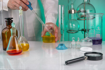 A scientist in a white coat works in a chemical laboratory