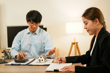 Businesswoman embraces client after successful property negotiation.
