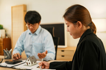 Businesswoman embraces client after successful property negotiation.