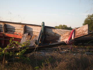 Wrecked fishing boat washed ashore by waves