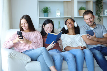 Four roommates or friends enjoying of different hobbies