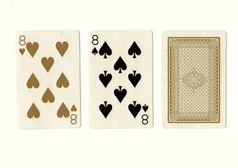 A hand of playing cards with a pair of the same value revealed in sepia.