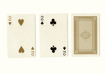 A hand of playing cards with a pair of the same value revealed in sepia.