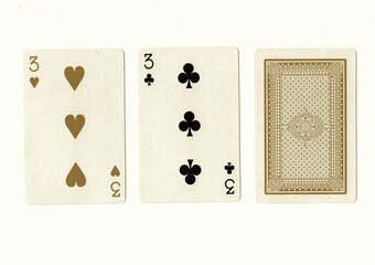 A hand of playing cards with a pair of the same value revealed in sepia.