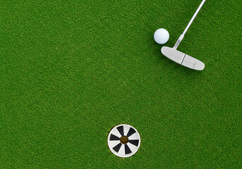 A Perfect Putt Awaits on the Green: Golf Putting Green Scene with Putter and Ball
