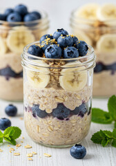 Delicious overnight oats layered with fresh blueberries and banana, ready to eat.