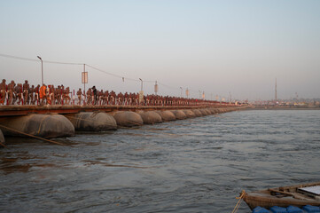 Prayagraj,India-27 pJanuary 2025 Newly made Saint Naga Sadhu going to his tent from Pipa Bridge or...