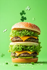 Stacked double patty burger with clover leaf confetti on a solid green backdrop
