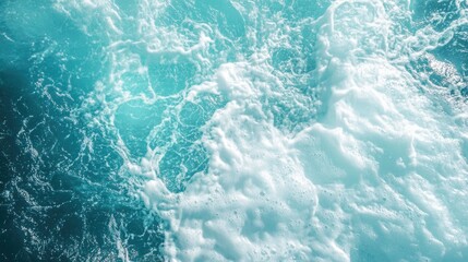 Naklejka premium Turbulent blue ocean water with foamy white waves at surface