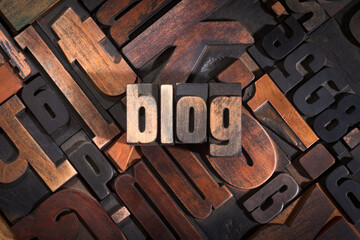 Blog, word written with antique letterpress printing blocks on random letters background