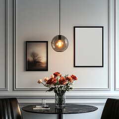 A picture frame mockup on the wall of an elegant home, a black marble table with flowers in front of it, white walls and ceiling, a modern hanging light above the table,
