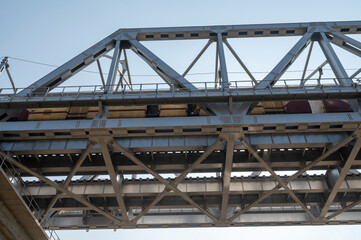 Naklejka premium Prayagraj,India-28 pJanuary 2025 View of the steel bridge on which the train is going at the Kumbh Mela in Prayagraj or Allahabad Uttar Pradesh India