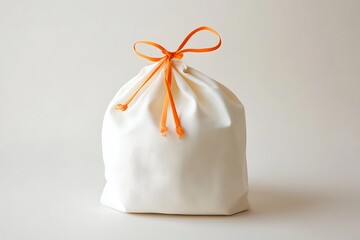 A white cloth bag with an orange drawstring is shown against a plain background
