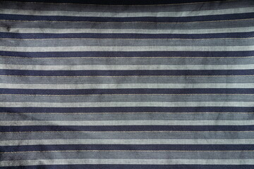 Top view of navy blue and grey striped cotton fabric