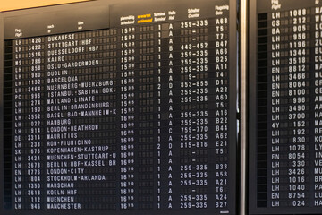 Main hall European airport main hall with black vintage mechanical flight information display...