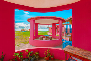 Vibrant Pink Gazebo with Scenic Outdoor Views. Colorful Kiosk in a Tranquil Garden Retreat