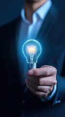 Man holding a light bulb representing business concepts of intellectual property protection and innovative ideas