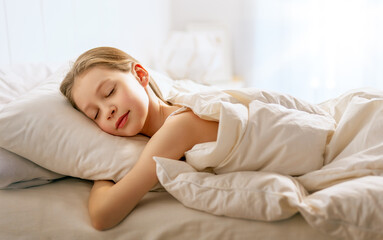 child is sleeping in the bed
