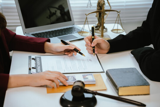 Professional lawyers consult with clients in the office on legal agreements, contracts and financial matters to ensure fairness and compliance with the law.
