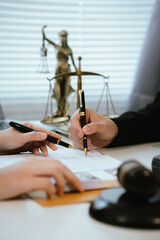 Professional lawyers consult with clients in the office on legal agreements, contracts and...