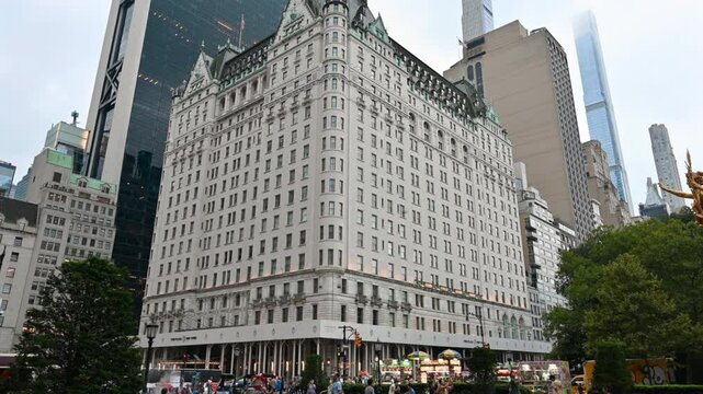 New York, USA, August 18, 2024. The imposing Plaza Hotel three-quarter view from Grand Army Plaza. People on the street, travel destinations.