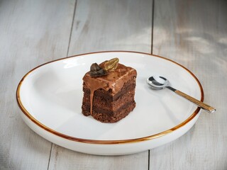 Delight in a rich chocolate amandine cake, beautifully presented on a vintage plate, capturing the essence of Romanian confectionery from the communist period