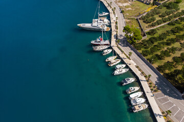 Scenic aerial view many yachts boats moored at Croatian bay harbor shore blue turquoise clear water...