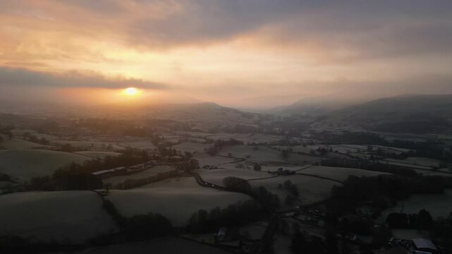 Stunning Drone footage of sunrise in the Yorkshire Dales above the village of Sedbergh. Dawn sunrise above the hills and misty landscape of the Yorkshire dales national Park.