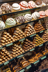 A display of many different types of pastries, including cupcakes and donuts
