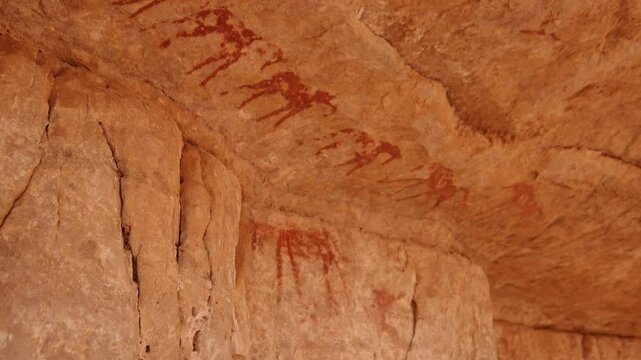 Neolithic rock art. Rock painting of a camel with rider. Tadrart Rouge. Tassili N'Ajjer National Park. Sahara Algerian Desert. Illizi Province, Djanet, Algeria, Africa