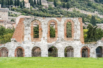 A large stone building with arched windows and a courtyard in Gubbio Italy Umbria. Archaeological...