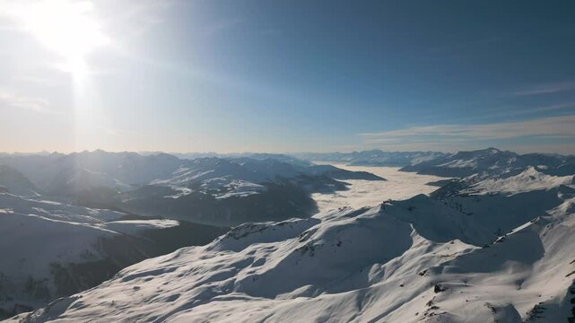 Expansive Alpine Landscape in Davos Klosters with Snowy Forests, Low-Hanging Clouds, and Majestic Peaks
