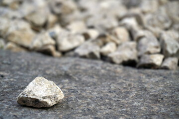 Close-up light beige and white small stones, gravel rugged backg