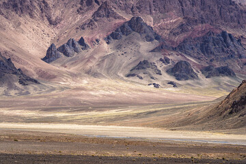 Colorful landscape detail of purple pink mountain slope in high altitude desert valley along Pamir Highway, Murghab, Gorno-Badakhshan, Tajikistan