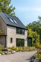 A contemporary stone house featuring expansive windows is beautifully positioned amid a vibrant green landscape, bathed in sunlight on a peaceful day in a serene neighborhood